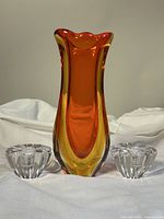Front view of amberina Murano Sommerso blown glass vase and pair of clear Orrefors crystal candleholders