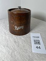 Front view of the antique oak tobacco jar with the metal script 'Baccy' on front and a lid with a knob