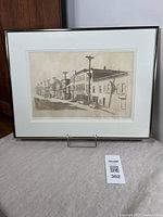 Framed etching of Clarence St. Ottawa secured on a stand showing full frame and artwork.