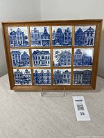 Frontal view of the framed tile set showing all 12 tiles and overall condition