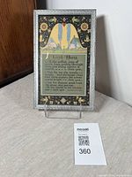 Framed art deco print displayed on a stand showing whole front view, indicating overall condition and colors.