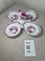 Porcelain dish with bird handle, showing all four scalloped bowls and floral design.