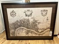 Full front view of framed map print on floor showing entire frame and map