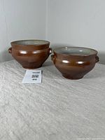 Pair of two antique French salt glazed stoneware bowls side by side showing overall size and color.