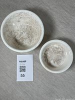 Top view showing interior of two nesting antique stoneware bowls revealing crazing and staining.