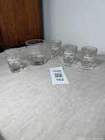 Set of 4 Seagram’s VO Canadian Whisky shot glasses with measurement markings and 1 matching tumbler glass. All in good vintage condition with intact graphics.