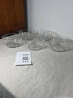 Five clear glass bowls arranged on cloth surface with a MaxSold lot card.