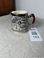 Side view of vintage Arthur Wood Silver Shield ceramic creamer showcasing textured gray and white pattern, silver-colored rim, and brown handle with golden tip.