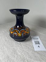 Side angled view showing vase shape and multicolor glaze pattern