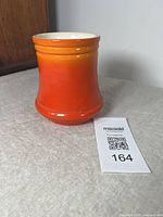 Front angled view of the vase showing the full body with gradient orange to red glaze and flared base.