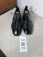 Front view of the vintage men's ballroom dance shoes showing black leather upper with creasing and square toes.