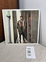 Front cover of Quadrophenia soundtrack vinyl record showing a young man standing in an alley.