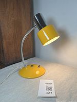 Desk lamp lit from above at an angle showing lamp design and light output