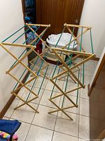 Both drying racks fully extended showing wood frames and teal rods