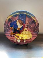 Front view of Beauty and the Beast porcelain collector plate on stand