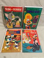 All four Gold Key comic books in bags with boards