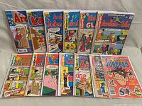 All 13 comics displayed upright in two rows