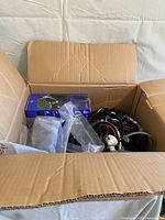 Box containing headsets, showing PDP LVL 3 box and tangle of wired headsets