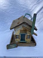 Front and side view showing overall birdhouse with detachable sign