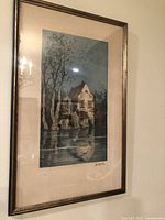Framed aquatint etching hanging on wall, showing the full art and frame.