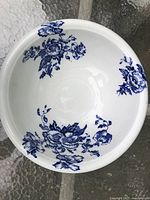 Overhead view showing blue floral transferware pattern inside the bowl with embossed flowers and glossy white ceramic.