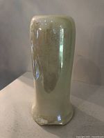 Front and side view of the cylindrical yellow lustre Royal Doulton miniature vase with Art Nouveau style and glossy finish