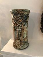 Front view of the vase highlighting the raised tree motifs and glaze finish.