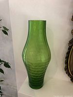 Front view of tall green Murano Battuto vase showing overall shape and color