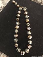 Full view of the vintage Murano art glass bead necklace on a black background showing the arrangement and color of the beads.