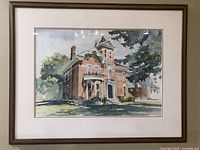 Full front view of the framed watercolor painting depicting a 19th century brick house.