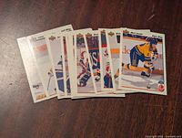Photo showing a spread of 15 Upper Deck 1991-92 hockey cards fanned out on a wooden surface.
