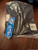 Adidas sacoche bag in sealed plastic bag with original blue Adidas tag and sticker showing product details and barcodes.