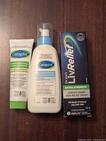 Photo of three new unopened skincare and pain relief products: Cetaphil Moisturizing Cream, Cetaphil Gentle Foaming Cleanser, Dr. Joe's LivRelief Pain Relief Cream.
