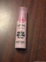 Light pink matte finish primer bottle with translucent matte pink cap, black text with NYX branding and product name.