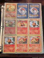 Photo showing plastic sleeve pages with nine Pokemon cards per page, front and back cards including Charmander, Emboar, Pignite, Tepig, and Rapidash Fire-type Pokemon.