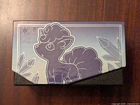 Top view of the Pokemon Silver Tempest Elite Trainer Box showing the purple gradient with Vulpix character and crystal motifs.