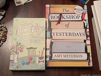 Both books are shown side by side on a table with 'Minding Frankie' on the left and 'The Bookshop of Yesterdays' on the right.