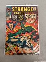 Front cover of Strange Tales #144 showing Nick Fury, Agent of S.H.I.E.L.D. and artwork with car, explosions and vibrant colors.
