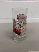 Front view of vintage 1982 Pizza Hut collectors drinking glass featuring colorful illustration of E.T. and a child.