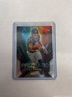 Front side of 2023 Prizm football rookie card featuring Houston Texans QB C.J. Stroud with prismatic holographic finish.