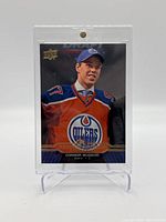 Front of 2015-16 Upper Deck Connor McDavid Oilers rookie card showing player portrait in Oilers jersey with Upper Deck logo.