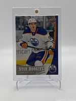 Front view of 2015-16 Upper Deck Connor McDavid NHL rookie card in protective hard plastic holder on stand