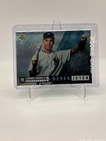 Front of the 1994 Upper Deck Derek Jeter Rookie Card in protective sleeve showing player photo and branding.