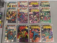 Full view of 12 Doctor Strange comic books arranged in two rows, including duplicates of some issues and visible colorful vintage comic book covers.