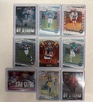 Front view of 9 rookie football sports cards laid out, various players and teams visible.