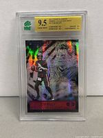 Front of the 2021 Panini Illusions Trophy Collection Dots Tom Brady football card with holographic dot pattern and grading label showing 9.5 Gem Mint.