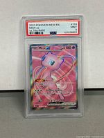 Front view of 2023 Pokémon Mew ex Ultra Rare card graded PSA 9 in protective slab showing artwork, stats, and card details.