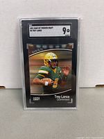 Front image of the 2021 Sage Hit Premier Draft Trey Lance rookie card showing the player in uniform with grading label of 9 from SGC.