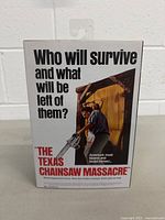 Back of box with movie tagline and character image holding a chainsaw.