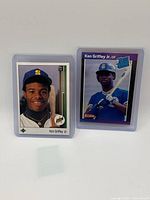 Two Ken Griffey Jr. baseball rookie cards, one Donruss and one Rated Rookie, both in protective sleeves